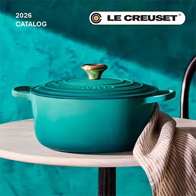 Le Creuset teal cast iron Dutch oven from 2026 catalog on tabletop, premium enameled cookware for professional kitchens